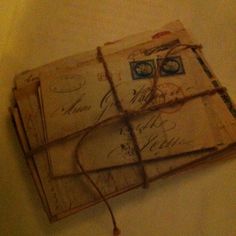 two old envelopes are tied together with twine