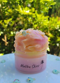 a close up of a small container on a table with trees in the back ground