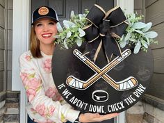 a woman holding up a sign with hockeys on it