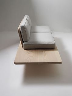 a couch sitting on top of a wooden table