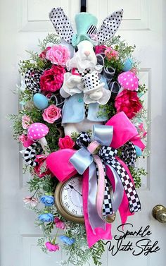 a clock decorated with pink, blue and white flowers is hanging on the front door