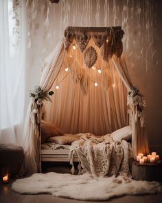 a canopy bed with lights hanging from it's sides and pillows on the floor