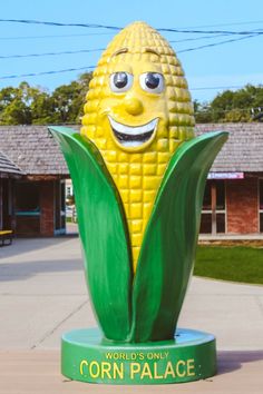 a statue of a corn cob on the sidewalk