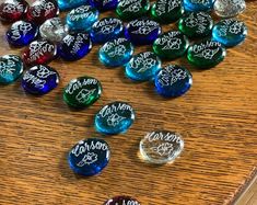 many different colored candy candies on a wooden table