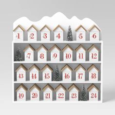 a white shelf filled with lots of wooden houses and numbers on top of each shelf