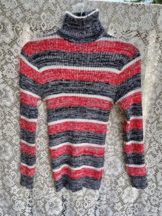 1960 1970 Vintage Striped turtleneck sweater, reminds me of "That 70s Show" Great condition, tag says size L Measurements: Shoulders-17" Pit to pit 18"  Bottom hem 18" length- 28" Shaulder to bottom sleeve - 23" Retro Long Sleeve Ribbed Sweater, Retro Ribbed Winter Tops, Striped Long Sleeve Turtleneck For Winter, Casual Striped Turtleneck For Fall, Vintage Long Sleeve Stretch Sweater, Striped Long Sleeve Casual Turtleneck, Casual Fitted Red Turtleneck, Casual Red Fitted Turtleneck, Vintage Turtleneck Tops For Fall