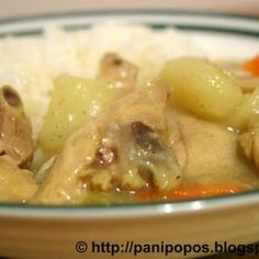 a bowl filled with rice and meat covered in gravy