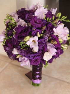 a bridal bouquet with purple and white flowers