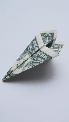 an origami boat made out of one dollar bill on a white surface with no background