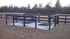 three empty benches in the middle of a field