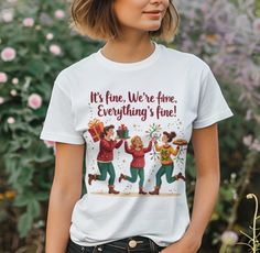 🎄 "It's Fine Holiday Moms" T-Shirt 🎁 Add a dash of humor to your holiday wardrobe! 🎄✨ Whether you're juggling gifts, untangling lights, or baking cookies, this T-shirt reminds you: It's fine. You're fine. Everything's fine! 💕 Order yours today and embrace the festive chaos in style. 🎁🎅 Celebrate the chaos and joy of the holiday season with this playful T-shirt featuring three busy moms in festive, cartoon-style illustrations! 🌟 Perfect for moms who do it all, this whimsical design captures the holiday hustle--wrapping gifts, untangling lights, and baking cookies--with the iconic phrase, "It's fine. We're fine. Everything is fine!" 😅 ✨ Description Highlights 🎨 Playful Holiday Design: A cheerful, festive graphic featuring three cartoon moms in colorful holiday sweaters. 🎁 Dynamic S Holiday Sweaters, Cartoon Mom, Holiday Apparel, Funny Christmas Gifts, Wrapping Gifts, Baking Cookies, Presents For Mom, Holiday Humor, Everything Is Fine