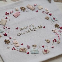 a cross stitch christmas card on a table