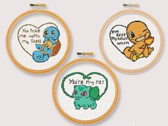 three cross stitch hoops with different designs on them, each featuring an image of pokemon and pikachu