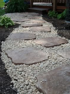 a garden path made out of rocks and gravel