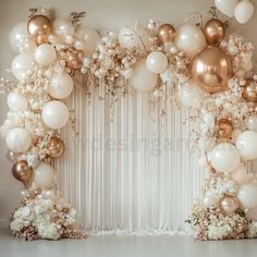 a white and gold balloon arch with flowers on the side for an elegant wedding backdrop