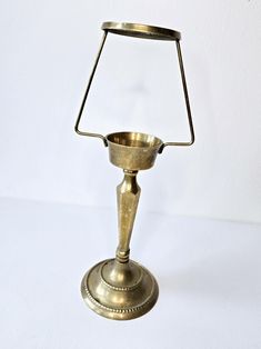 an antique brass candle holder on a white background