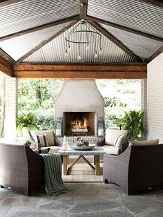 an outdoor living area with fireplace and couches