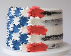 a close up of a cake with red, white and blue frosting on it