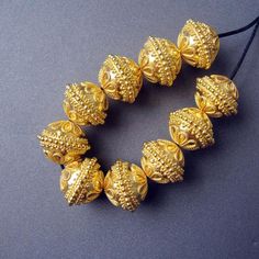 18k gold beadSolid 18 carat yellow gold12x15mm approximatelyLarge big focal ornate granulated designer beadHandmadeNo stamp2.80gr per bead approximatelyChoose quantity from the menu.BREATHTAKINGLY BEAUTIFUL. Gold Bolls Design, Golden Beads Necklace, Gold Temple Jewelry Necklaces With Large Beads, Gold Temple Jewelry Necklace With Large Beads, Elegant Gold Beads For Formal Occasions, Gold Jewelry With Large Round Beads, Gold Large Beads For Jewelry Making, Large Gold Beads For Jewelry Making, Gold Oval Beads For Wedding