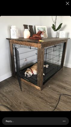 a dog is laying in its cage on the floor next to a table with pictures