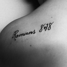 the back of a woman's shoulder with roman numerals tattoo on it