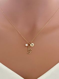 "Handmade Initial Music Charm and Pearl Necklace. Gift for wife, girlfriend, sister ,Niece, bridesmaids, Musician friends, birthday, and anniversary Gold Music Charm is made by 14k Gold Fill Wire By me(Not Gold Plated). Suitable For all Sensitive Skin ...It is a little hammered on Music Note Charm. This Delicate Necklace Consist of ... -16mm x 7mm 14k Gold Fill  or Sterling Silver Music Charm -7mm 14k Gold Fill / Sterling silver initial disc ( Highlight  or Non-Highlight on Initial letter ), -14 Personalized Gold Music-themed Jewelry, Music-themed Personalized Necklaces For Anniversary, Personalized Music-themed Necklaces For Anniversary, Necklace Aesthetic Pearl, Music Note Jewelry, Music Sign, Music Note Necklace, Note Music, Music Necklace