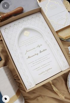 the wedding stationery is laid out in an open box and ready for guests to arrive