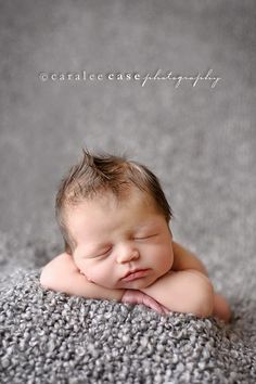 a baby is laying down on the carpet with his eyes closed and it's head resting