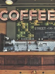 a coffee shop with the word coffee on it's sign above the counter,