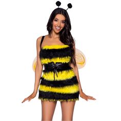 a woman wearing a bee costume with black and yellow feathers on her chest, standing in front of a white background