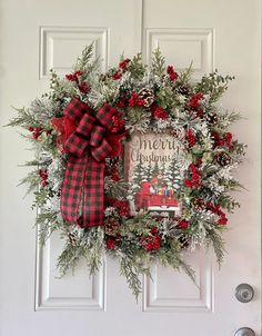 a christmas wreath hanging on the front door