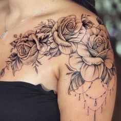 a woman's chest with roses and pearls on it