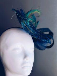 Transform your midnight look with our stunning peacock Fascinator Hat, adorned with butterflies in various shades of Blue and black with hints of green. This whimsical headpiece is perfect for adding a touch of magic and sophistication to any special event! Age Group/Gender - Adult/Women Size/Type - One size fits all adults Color - Blues, green and touch of black Special Features - peacock feathers on fascinator base Whimsical Headpiece, Fitted Blue Headpieces With Feathers, Peacock Fascinator, Summer Purple Feathered Fascinator, Blue Feathered Summer Fascinator, Kids Party Packs, Butterfly Fascinator, Spring Blue Feathered Fascinator, Butterflies Purple