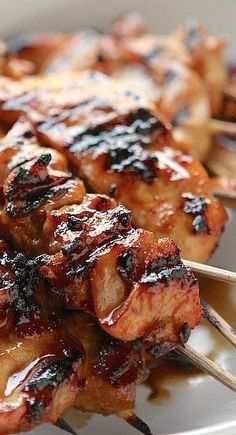 the skewers are covered with barbecue sauce and meat on them, ready to be eaten