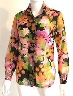 "Just beautiful vintage C1960s transparent nylon long sleeve multicolor jewel toned blouse, top, in an allover floral pattern, featuring a forward pointed collar and self covered buttons. Approximate Measurements:     Chest: 38\"; Shoulder: 17\"; Waist: 34\"; Hips: 38\"; Length: 26\"     Size label removed; likely a size M based on measurements Fabric:  Fabric label removed; feels like nylon Condition: C1960s retro top is in very good vintage condition; some hard to see marks." Womens Blouses, White Plains, Retro Tops, Fabric Labels, Pretty Green, Size Label, Jewel Tones, Body Suit, Covered Buttons