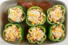 green peppers stuffed with cheese and sauce in a casserole dish