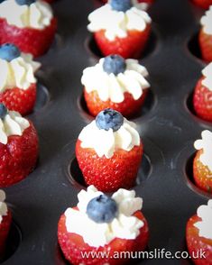 red, white and blue cupcakes with strawberries in the shape of flowers