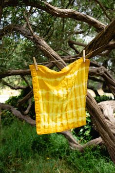 a yellow cloth hanging from a clothes line