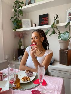 a woman sitting at a table with food in front of her