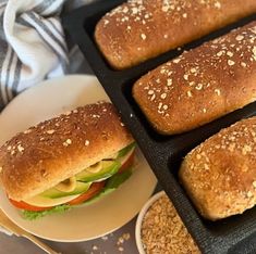 bread rolls sitting on top of a white plate