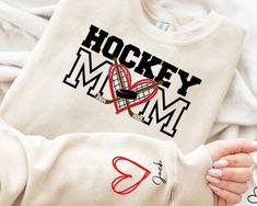 Custom Hockey Mom Sweatshirt, Game Day Shirt For Mom, Personalized Cheer Mom Sweater, Sports Mom Sweatshirt,Custom Hockey Gift,Hockey Season ---How To Order --- 1-) Please, check and review all photos 2-) Choose your t-shirt size and color 3-) Click add to cart. You can go back to add more product 4-)Click "Proceed to check out" 5-)When you check out, you can add a note to seller for any request ---Production and Shipping--- * High quality and super soft, comfortable shirt. Made with top-of-the-line vinyl and pressed with a professional grade heat press. * Since all shirts are custom made based on your selection, We don't accept return or exchange unless there is an issue with your order. * Processing time is 1-3 days. Shipping time is based on the shipping type you'll select at checkout. Hockey Season, Hockey Gifts, Mom Sweater, Hockey Mom, Game Day Shirts, Cheer Mom, Mom Sweatshirt, Sports Mom, Hockey