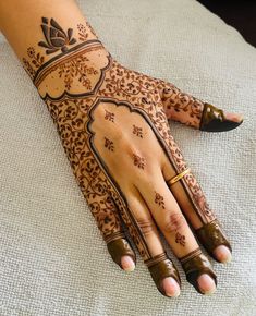 a woman's hand with henna tattoos on it