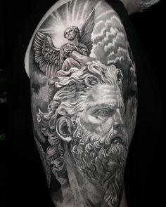 the back of a man's shoulder with an angel and demon on it