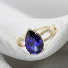 A Sapphire ring ring rich with presence and diamonds. Flaunting a beautiful pear cut Sapphire corundum prong set in your choice of solid gold. Handmade by an inspired jewelry artist team with decades of experience in the craft of jewelry making. Each gemstone, each diamond is carefully picked. Using only the finest raw materials and the highest industry standard in manufacturing, design and finish. A beautiful vintage inspired piece handmade just for you. Set with a 12x8 pear cut blue sapphire c Elegant Pear-shaped Yellow Gold Birthstone Ring, Teardrop Gemstone Ring For Formal Occasions, Teardrop Cubic Zirconia Diamond Ring For Anniversary, Fine Jewelry Pear-shaped Sapphire Ring For Formal Occasions, Pear-shaped Sapphire Ring Fine Jewelry For Formal Occasions, Formal Pear-shaped Sapphire Ring In Fine Jewelry Style, Pear-shaped Brilliant Cut Sapphire Ring With Cubic Zirconia, Pear-shaped Sapphire Ring For Formal Occasions, Anniversary Teardrop Cubic Zirconia Ring