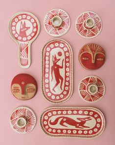 several red and white decorative items on a pink surface