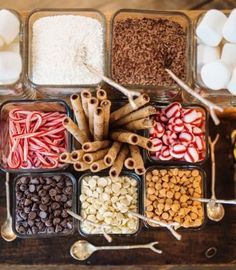 an assortment of candies and marshmallows in containers