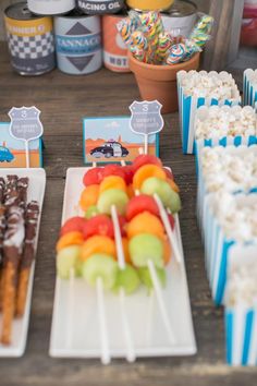 an assortment of desserts and snacks are on the table at a camper themed birthday party