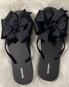 A pair of Old Navy flip-flops with a hand sewn 5 inch grosgrain solid black bow attached. Ribbon used is a solid black two inch width type. Edges of bow are heat sealed to prevent fraying. Flip flops are made to order. These are perfect for bridesmaid gifts, lounging by the pool or to add a little style to an outfit!! Custom orders are always welcome please send me a message and I will respond as quickly as possible. Thank you for stopping by!! Old Navy Flip Flops, Rubber Flip Flops, Black Flip Flops, Cute Sandals, Big Bows, Black Bow, Tongs, Flip Flop, Womens Flip Flop