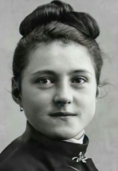 a black and white photo of a woman wearing a topknoted hairdo