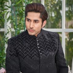 "Make an edgy statement with our BLACK SILVER EMBROIDERED INDO WESTERN designed thoughtfully for the modern Indian man. A fusion staple fit for every occasion, adds the right amount of cultural twist to the western silhouette. Color: Black  Garment Type: Indo Western Neck: Mandarin Collar Fabric: Micro Velvet Embroidery: Zari work with sequin embroidery The Product Price is inclusive of: 1 Indo-Western and 1 Trouser Style Bottom Model is 6'2\" wearing Size 38 Product color may slightly vary due to photographic lighting sources or your screen settings." Festive Black Semi-stitched Bandhgala, Black Semi-stitched Elegant Sherwani, Elegant Black Semi-stitched Sherwani, Traditional Black Sherwani For Party, Black Sherwani With Dabka Work For Party, Black Traditional Drape Sherwani For Party, Black Sherwani With Resham Embroidery For Party, Black Sherwani For Party With Traditional Drape, Black Sherwani For Party And Festivals